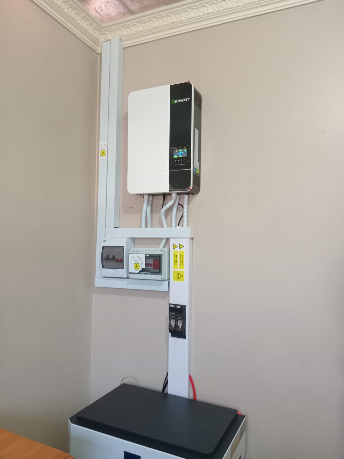 Growatt hybrid inverter installation on white wall bracket